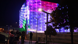 Illustration for article titled Watch an entire building transform into a playable Rubik's Cube